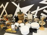 a kitchen counter with a lot of dishes and utensils on it