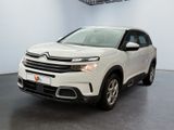 the white citrole suv is parked in a showroom