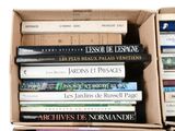 many books in a box that are stacked on top of each other