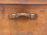 a brown suitcase that has a handle on top of it