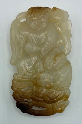 une image représentant une statue sculptée d'une personne assise sur un rocher