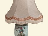a lamp that is sitting on a table with a lamp shade on it
