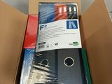 a cardboard box with a bunch of binders inside of it