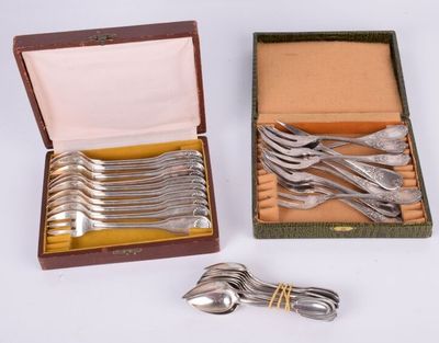 a lot of silver spoons and forks in a box