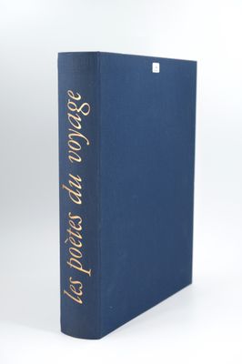 a blue book with gold lettering on it sitting on a white surface