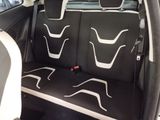 the back seats of a car with a black and white seat cover
