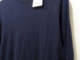a close up of a shirt hanging on a hanger on a wall