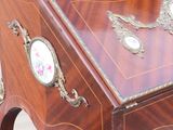 a small wooden desk with a clock on top of it