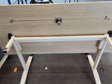 a wooden table with a metal handle on it in a room