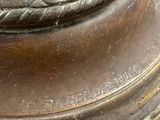 a close up of a bronze statue of a bird on top of a pedestal