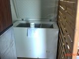 a small refrigerator in the corner of a room