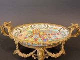 an ornately decorated tray with a clock on it