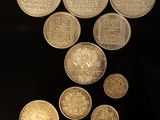 a lot of coins that are on a black surface