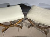 pair of stools with white upholstered seats on a tiled floor