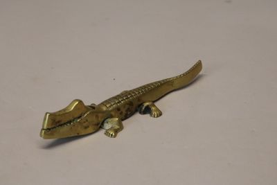 un petit lézard doré posé sur une table