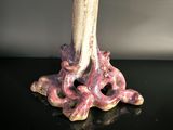 a vase that has a candle inside of it on a table