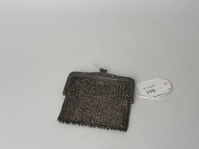 an old purse with a tag on it sitting on a table