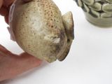 a person that is holding a small object in their hand
