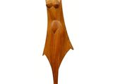 a wooden sculpture of a woman with a hat on her head