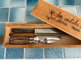 three knives in a wooden box on a tiled floor