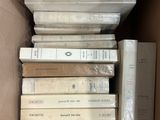 a box full of books that are stacked on top of each other