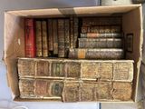 a box full of old books sitting on a table
