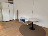 a white refrigerator and a table in a room