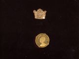 une pièce d'or sur laquelle est représentée une couronne, surmontée d'une autre couronne