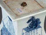 a small blue and white vase with a bird on it