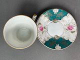 two tea cups and saucers are sitting on a table
