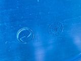 a close up of a blue surfboard on a blue surface