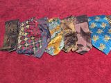 five different types of ties laid out on a red surface