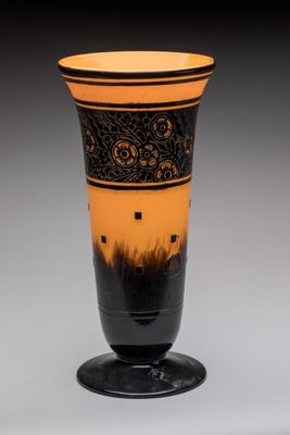 a black and orange vase sitting on top of a table