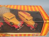 a box with two toy cars in it on a table