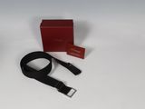 an image of a black belt and a red box on a white surface