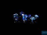 a close up of a group of blue crystals on a black surface