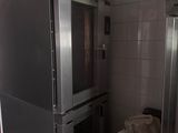 a silver oven sitting in the middle of a kitchen