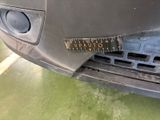 a close up of a car ' s front bumper with a ruler on it