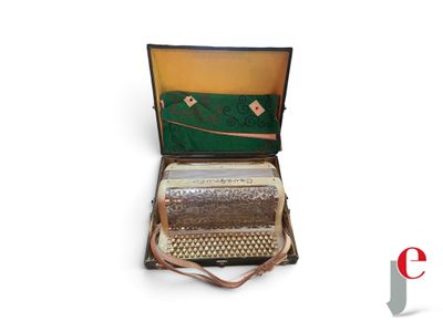 a suitcase with a accordion inside of it on a white surface