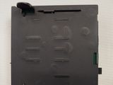 the back of a laptop with a green button on the side of it