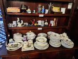 a china cabinet with a lot of dishes and cups on it