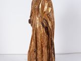 a wooden statue of a man in a golden robe