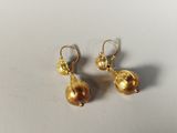 pair of gold plated earrings on white surface with white background