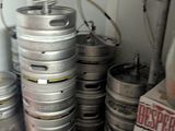 many kegs stacked on top of each other in a room