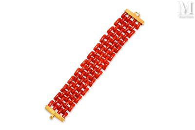 a close up of a red bracelet on a white background