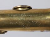 an image of a gold saxophone with a black label on it