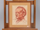 portrait of a man in a suit and tie sitting in front of a wooden easel