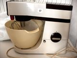a mixer that is sitting on a counter next to a bowl
