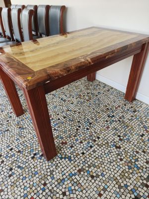 a wooden table with a wooden top on a tiled floor