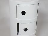 a white trash can with three drawers on top of it
